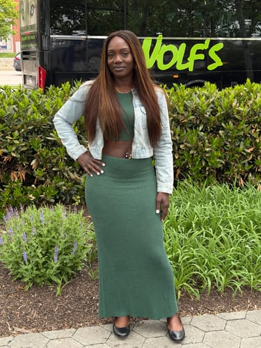 Reviewer standing outdoors in the green Ribbed Knit Crop Top and matching maxi skirt, styled with a denim jacket.