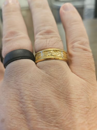 Customer's hand showing the perfect fit of the shiny, textured Aureum ring.