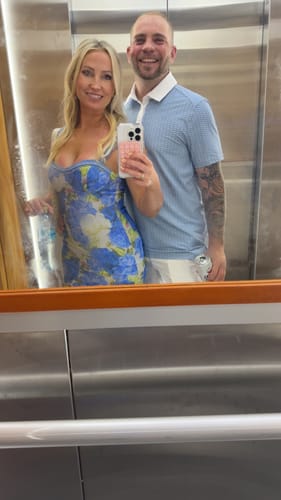 Customer's mirror selfie showing the top of the blue Azurae Floral Maxi Dress, highlighting the sweetheart neckline.