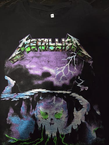 Customer's black Metallica 'Creeping Death' shortsleeve shirt, showing the purple and green graphic.
