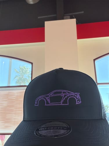 Customer's black 80Eighty DCG88 hat with a purple embroidered outline of a sports car.