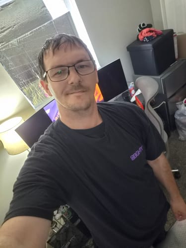 Reviewer in a room wearing the black 80Eighty® Limited Edition DCG88 Shirt.