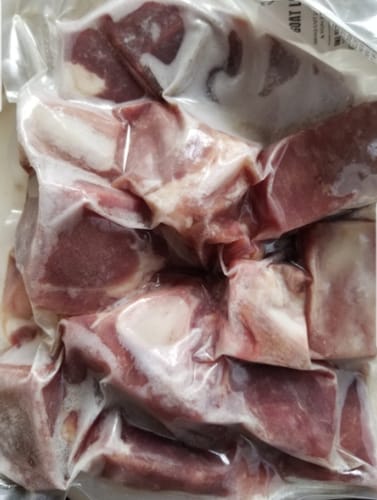 Customer's Halal Goat Leg, cut into large chunks and vacuum-sealed in a clear package.