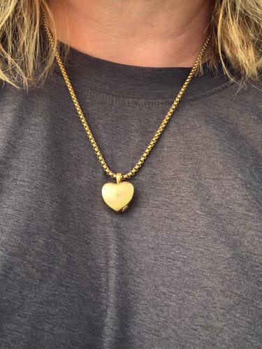 Customer wearing the beautiful gold Heart Urn as a necklace.