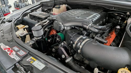 Customer's black Top Loader Billet Oil Catch Can installed in a clean car engine bay.