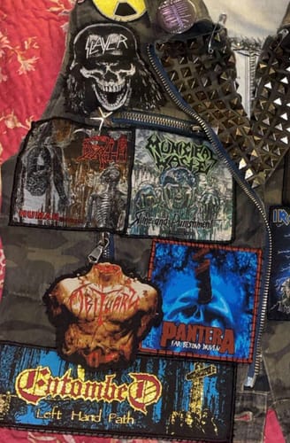Reviewer's Obituary - Inked in Blood patch sewn onto a camouflage battle jacket among other patches.