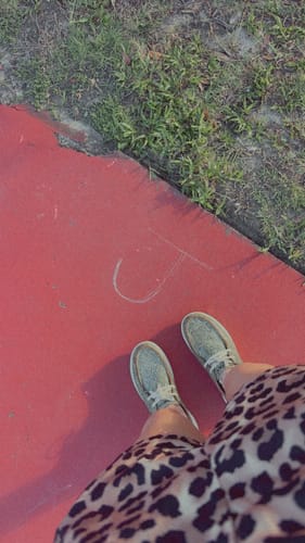 A reviewer's view looking down at their sparkly, gray Women's Hilo Shoes.