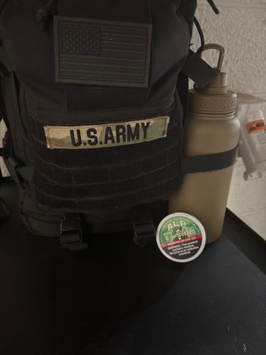 Customer's can of Drifters Watermelon Kiwi Ice pouches in front of a black U.S. Army backpack.