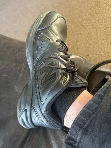 Customer showing the cushioned black Ankle Sock peeking out of a black shoe.