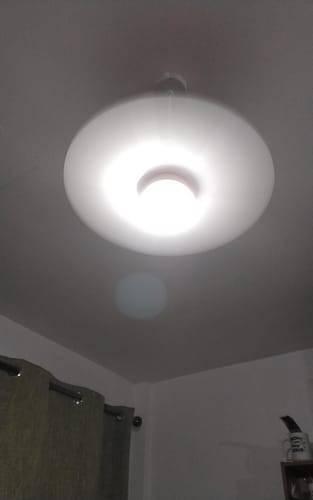Customer's white portable ceiling fan and light installed on a ceiling, glowing brightly with the light on.