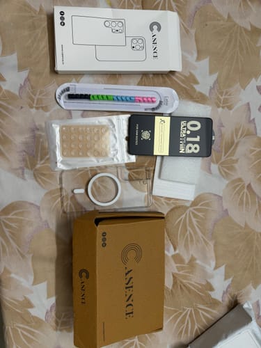 Customer's Anti Yellow Magsafe Clear Case and included freebies like a screen guard and cable organizer laid out with the packaging.