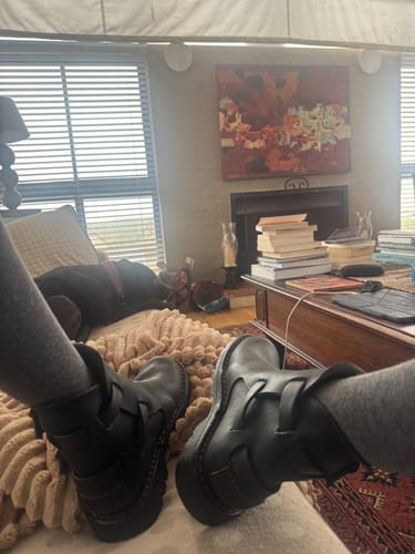Customer relaxing with their feet up, showing off their Black Tankwa Boot in a living room.