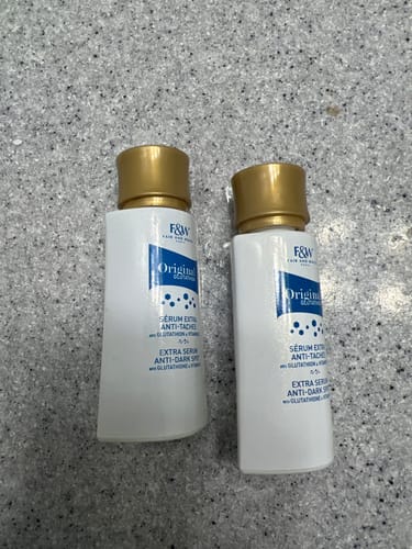 Customer's two bottles of Fair & White Glutathion Extra Anti-Dark Spot Serum on a countertop.