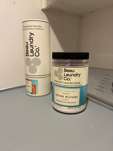 Customer's packaging for Azure Waters Scented & Softening Dryer Balls on a laundry machine.