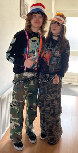 Reviewer wearing the black Death - Spiritual Healing longsleeve shirt with decorated sleeves, standing next to another person.