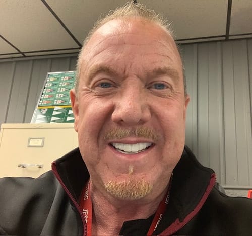 A satisfied reviewer smiles, showing off their bright, white Pop On Veneers.
