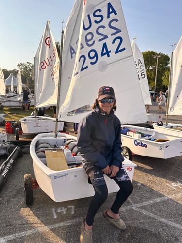 Customer wearing the Psalm 56:3 'Cross' Youth Performance Shorts over leggings while by a sailboat.