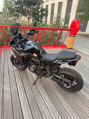 Customer's black Yamaha Tracer 7 with a clean tail tidy, parked on a wooden deck.