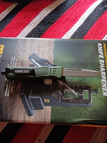 Customer's green Small Phantom OTF knife with the tanto blade deployed.