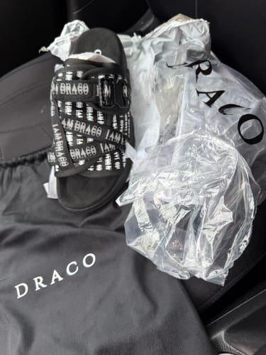 Customer's new 'I AM DRACO' SLIDES shown with the black Draco dust bag and clear packaging.