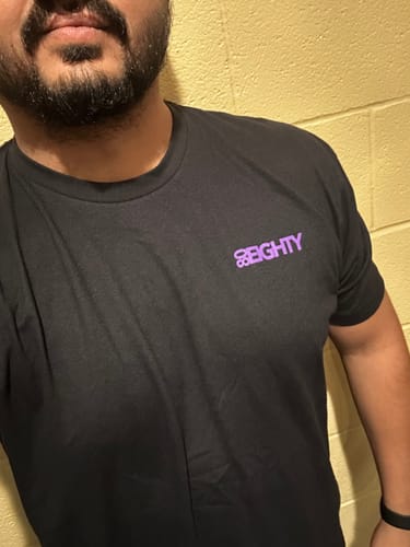 Customer wearing the black 80Eighty® DCG88 Shirt, showing the fit and small purple logo on the chest.
