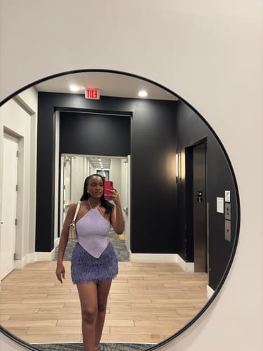 Reviewer's mirror selfie wearing the feathery, blue Faux Feather Mini Skirt.