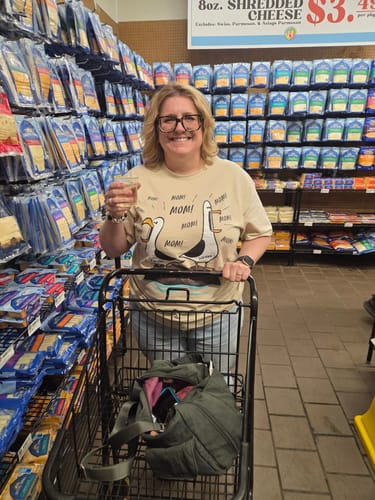 Customer wearing the personalized Seagull Mom Mom Mom shirt while pushing a shopping cart in a grocery store.