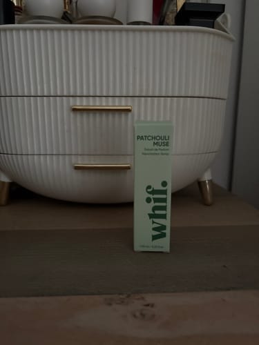 Customer's light green box for Patchouli Muse perfume on a wooden dresser.