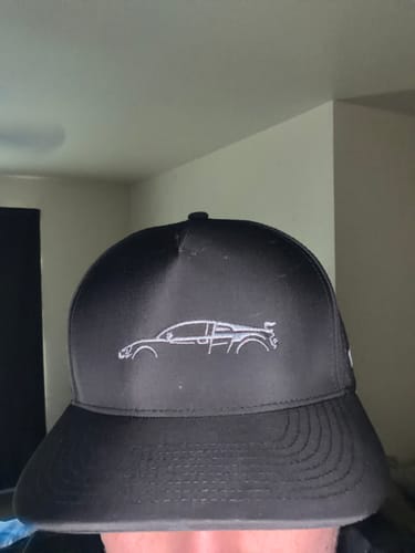 Customer wearing the black 80Eighty DCG89 Hat, showing the embroidered car outline.