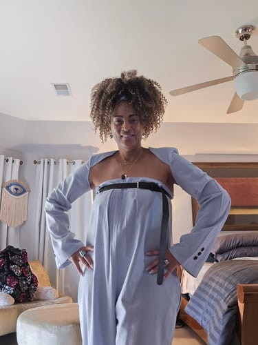 Reviewer posing in the two-piece set, showing the wide-leg jumpsuit and separate long-sleeved top.