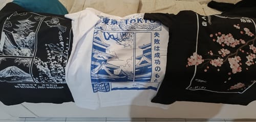 Customer's black Cherry Blossom T-Shirt laid out with two other Japanese-style graphic tees.