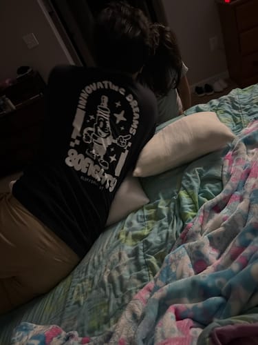 Reviewer seen from behind wearing the black 80Eighty Lil' Sparky Shirt in a bedroom.