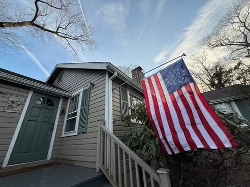 Reviewer's 1776 to 2026 Betsy Ross Flag displayed on a pole outside the front of their home.