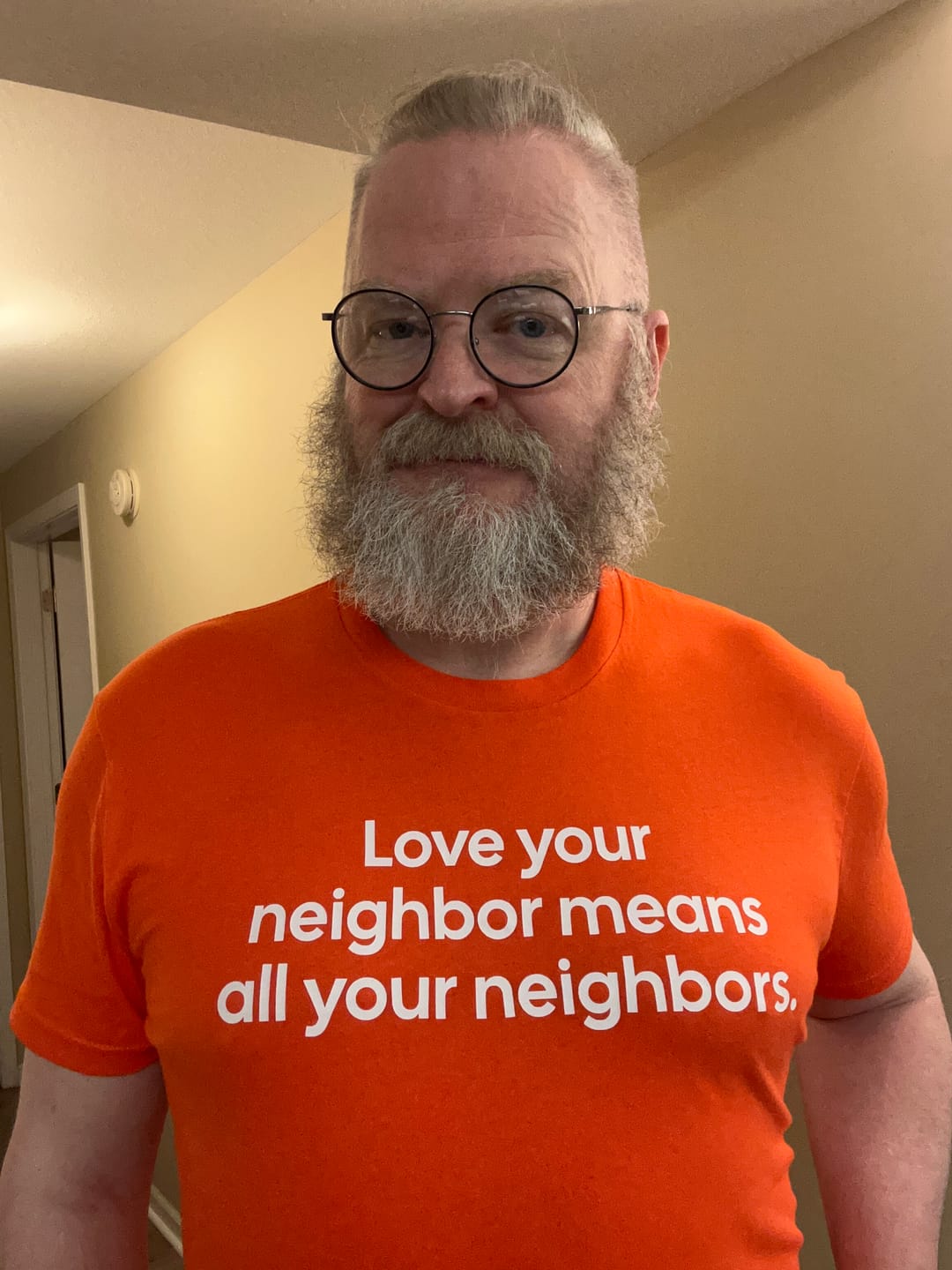 Customer photo review of Love Your Neighbor Means All Your Neighbors Unisex Tee