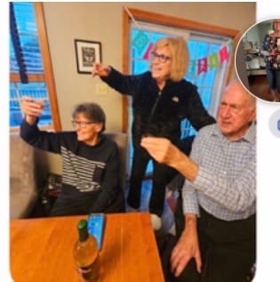 Partial view of a customer's photo showing three people raising glasses in a toast.