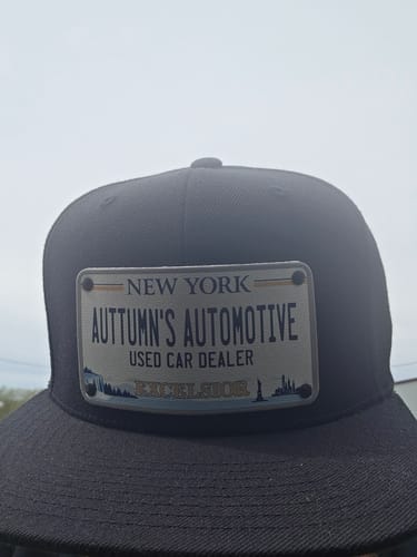 Customer's black New York Plate Hat with a custom patch for 'Auttumn's Automotive'.