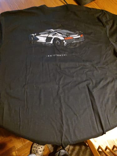 Customer's black 80Eighty Limited Edition DCG89 Shirt laid out, showing the white sports car graphic on the back.