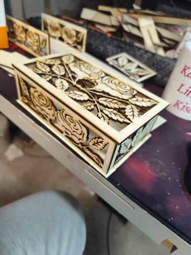 A customer's intricate, laser-cut wooden box with a rose design, made using an AtomStack engraver.