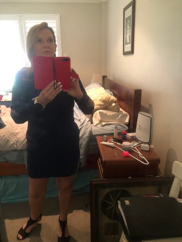 Reviewer taking a mirror selfie after using the Seranova Micro Infusion System.