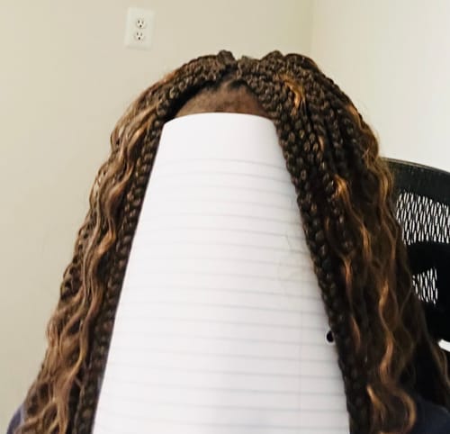 Close-up of a reviewer's long, highlighted Bobbi Boss Boho Box Braids with curly ends.