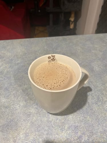 Customer's PM Blend Hot Chocolate prepared in a white mug, showing a frothy top.
