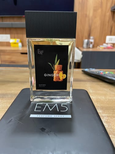 Customer's Ginger 50ml Perfume Spray bottle with a black cap, standing on its black product box.
