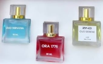 Reviewer's OUD Supreme BUNDLE showing the three distinct perfume bottles: Oud Nirvana, Ora 1776, and Oud Serene.