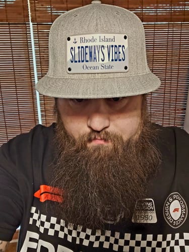 Reviewer wearing a gray Rhode Island Plate Hat with a custom 'SLIDEWAYS VIBES' patch.