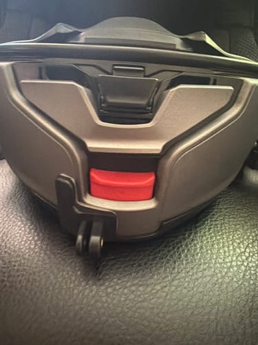 Customer's close-up of the Shoei Neotec 3 Camera Mount on a helmet, with clear access to the red chin bar release button.