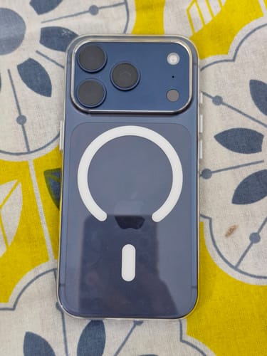 Reviewer's blue iPhone from the back, fitted with the Anti Yellow Magsafe Clear Case showing the magnetic ring.