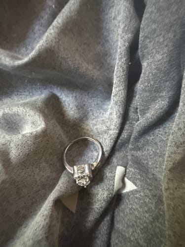 Customer's silver Forever In My Heart Urn Ring resting on a piece of grey fabric.