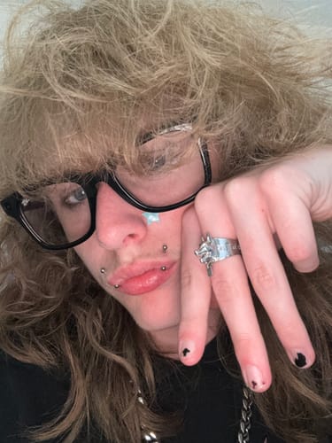 Close-up of a reviewer wearing the 1M MYSTERY JEWELRY RING, a silver ring sculpted to look like a wolf's head.