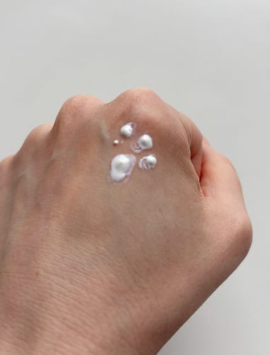 Customer shows the Biore UV Kids Stamp sunscreen dispensed in an imperfect paw shape on the back of a hand.
