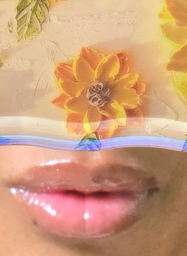 Close-up of a reviewer's lips showing the shiny, tinted Ruby Kisses lip gloss.